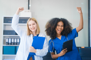 Young African American and Russian woman, both scientists, collaborate to analyze blood samples,...