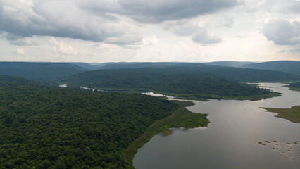 Drone shot. Aerial view scenic landscape of a large river delta amid a lush forest at the tropical...
