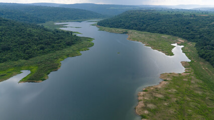 Drone shot. Aerial view scenic landscape of a large river delta amid a lush forest at the tropical...