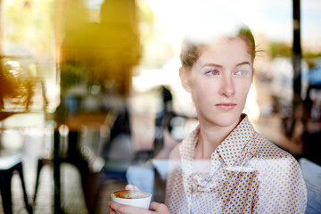 Thinking, window and woman in cafe, calm and relax with drink in morning, reflection and consumer. Glass, customer and person with tea for breakfast, enjoy and warm beverage for break in coffee shop
