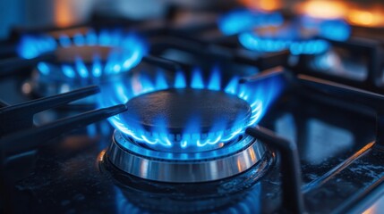 A close-up shot of a gas stove with two burners ignited, showcasing the mesmerizing blue flames dancing upwards, creating a captivating display of energy and heat.  