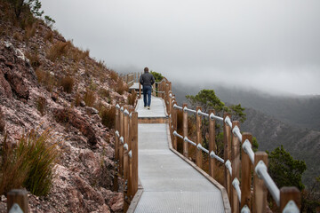 man behind walking path hike mountains cold winter jacket