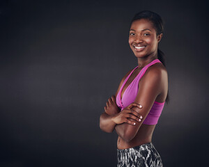 Arms crossed, fitness and portrait of black woman in studio for health, personal trainer and gym workout. Wellness, training and mockup space with person from Ghana on dark background for exercise