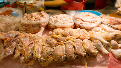 A vibrant market scene with Chinese and Thai food stalls serving grilled meats, seafood, and delicious desserts