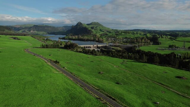 Panoramic aerial view of the Whakamaru Dam and Hydroelectric Power Station on the Waikato River, located in the small town of Whakamaru, New Zealand.