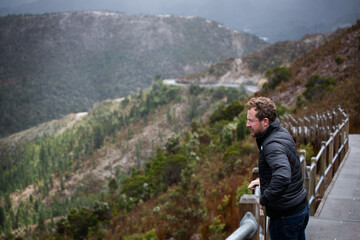 man behind walking path hike mountains cold winter jacket