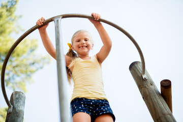 Smile, playground and pole with girl in park for growth, adventure and climbing games. Low angle,...