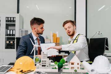 Engineer Teamwork Meeting, Drawing working on blueprint meeting for project working with partner on model building at company office.
