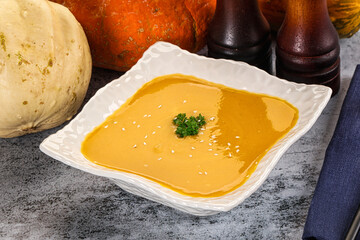 Vegan pumpkin cream soup served sesam