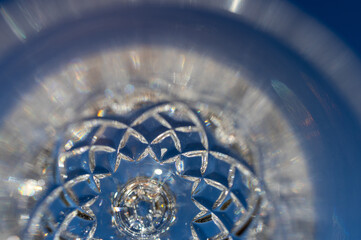 Defocused macro abstract texture background view of a beautiful lead crystal goblet surface with diamond facet cuts