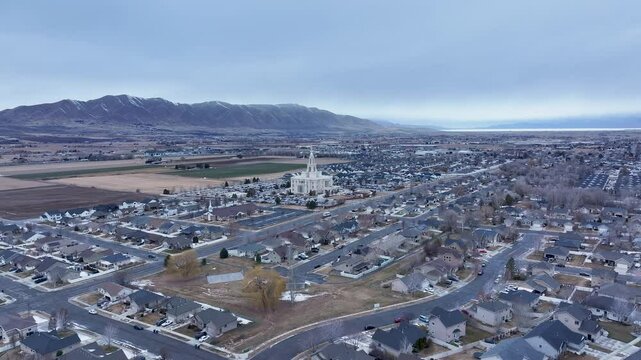 Aerial Payson Utah LDS Temple valley 1 4K. The Church of Jesus Christ of Latter-day Saints, LDS or Mormon religion. Sacred building for eternal worship. Residential neighborhood.