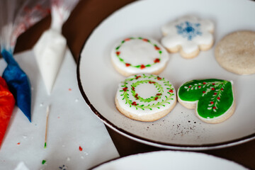 a table with gingerbread and accessories to paint them