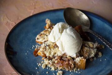 summer fruits crumble with a scoop of vanilla ice cream