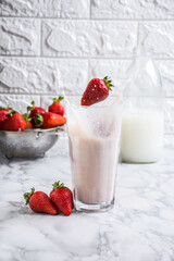 Freeze motion captured - strawberry tossed in milk shake glass