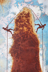Two climbers using same rope to climb different sides