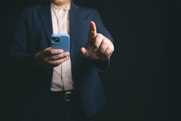 man in suit using smartphone, pointing with one finger