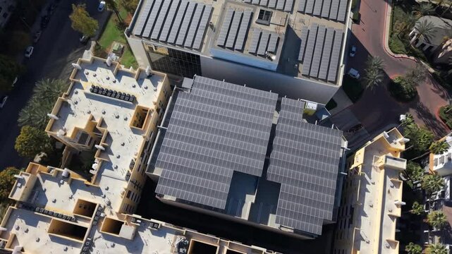 Solar Panels On A The Rooftop Of Commercial Buildings In Los Angeles. Rotating Top Down Drone Shot.