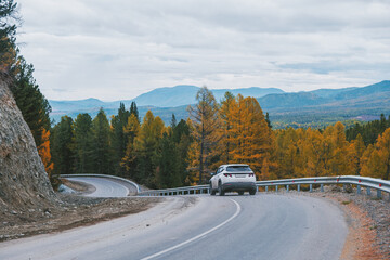 Car on a mountain serpentine road in autumn