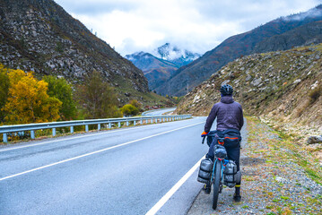 Man on a bicycle on a mountain serpentine road
