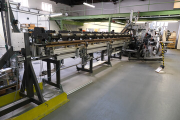 A complex machine stands in a factory hall