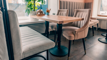 Empty beige upholstered chairs in a coffee shop in the morning