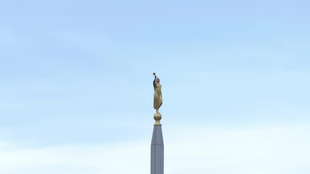 Aerial LDS Temple spire Angel Moroni Payson Utah circle 4K. The Church of Jesus Christ of Latter-day Saints, LDS or Mormon religion. Sacred building for eternal worship. Residential neighborhood.