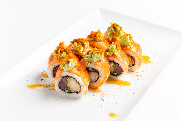 Delight in the artistry of sushi as fresh rolls are elegantly topped with creamy wasabi and zesty spicy mayo, highlighting culinary skill. A feast for the senses awaits. 