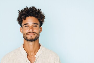 Obraz premium portrait of non-binary person with natural curls wearing soft linen shirt