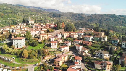 Naklejka premium Stunning aerial panorama of Barga, Garfagnana, with clear skies and scenic landscapes