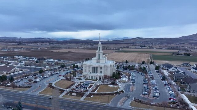 Aerial LDS Temple Payson Utah mountain valley circle fast 4K. The Church of Jesus Christ of Latter-day Saints, LDS or Mormon religion. Sacred building for eternal worship. Residential neighborhood.