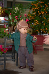 there is a small child standing in a flower shop
