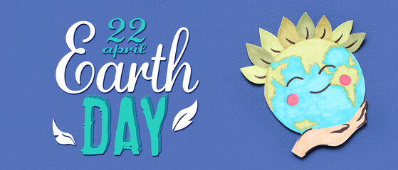 Paper planet Earth with hand on blue background. Earth Day celebration.