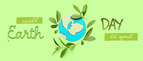 Paper planet Earth with green leaves on color background. Ecology concept