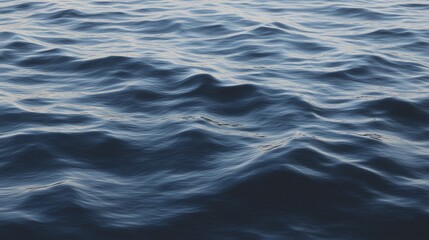 Naklejka premium Deep blue waves of the ocean creating texture and pattern across the surface