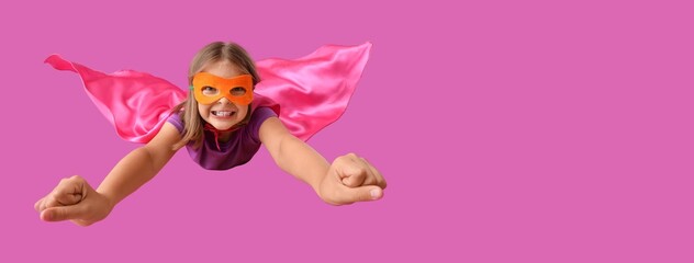 Fototapeta premium Little girl dressed as superhero flying on purple background with space for text