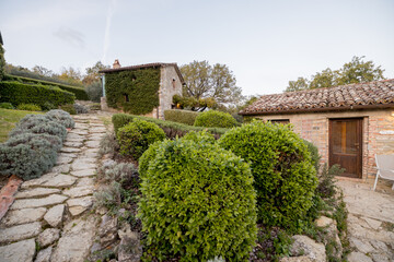A charming stone cottage nestled in a serene countryside landscape, surrounded by lush greenery and...