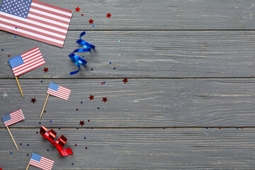 USA flags with stars and serpentine on color background. Independence Day celebration