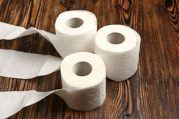 Rolls of toilet paper on wooden background