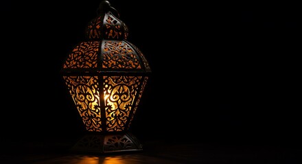 Ornate Metal Lantern Illuminated in Dark Background
