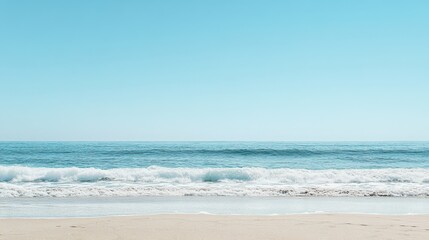 Fototapeta premium Tranquil Beach Scene with Soft Sand, Gentle Waves, and Clear Blue Sky Featuring a Peaceful and Relaxing Coastal Environment Ideal for Beach-Themed Content and Vacation Imagery
