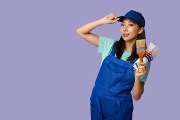 Female Asian painter with brush and paint color palettes on purple background