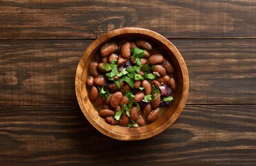 Baked beans in bowl on wooden table