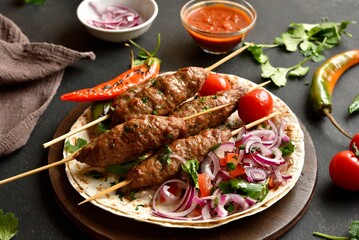 Grilled lula kebab with fresh vegetables on flat bread