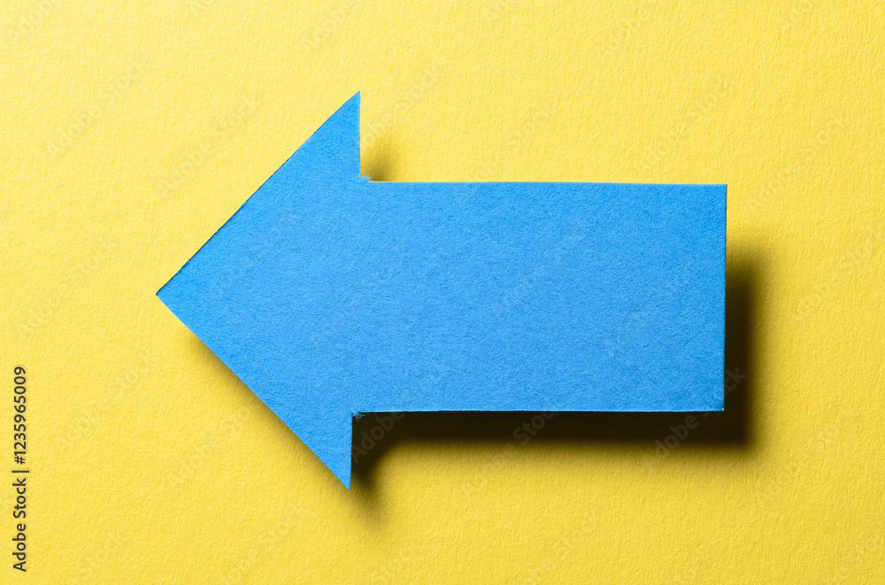 Poster blue cut out blank paper cardboard arrow direction sign with copy space for text on yellow backgroun