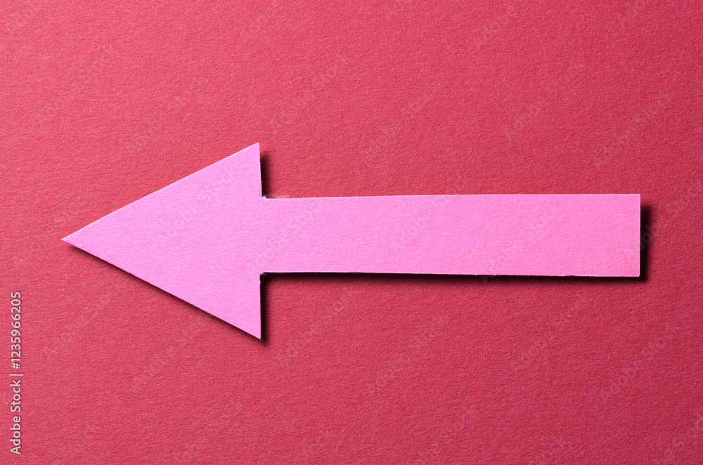 Aufkleber pink cut out blank paper cardboard arrow direction sign with copy space for text on red background, 