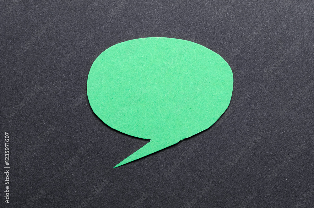 Poster green cut out blank paper speech bubble of round shape with copy space for text on dark background, 