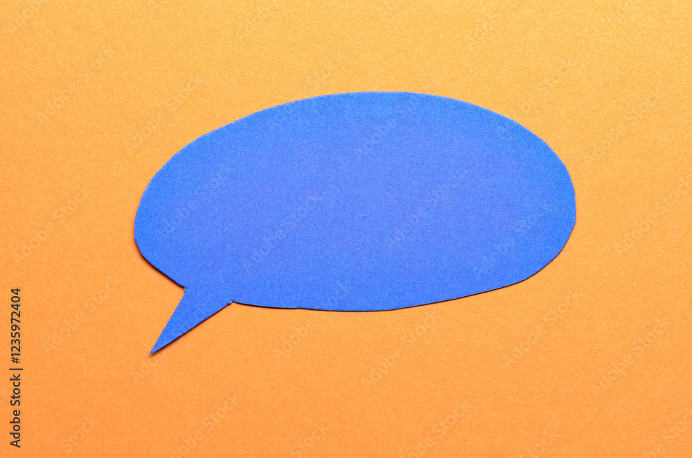 Poster blue cut out blank paper speech bubble of round shape with copy space for text on orange background,