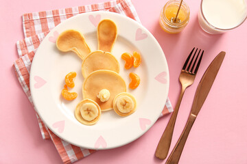 Funny Easter bunny pancakes with banana on pink background