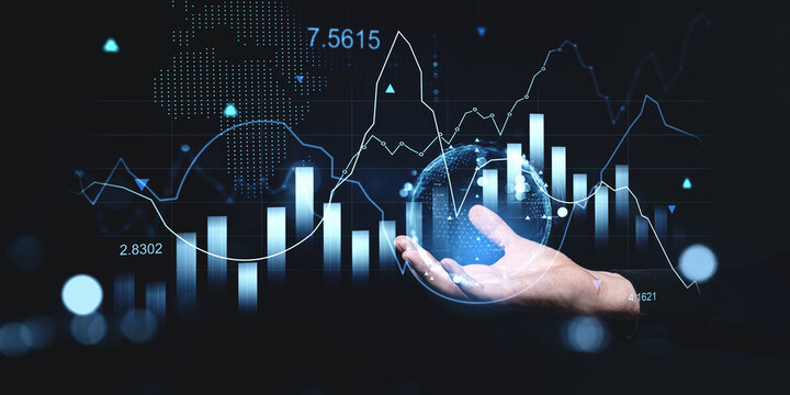 Financial chart and graphs with hand holding digital globe on dark background.