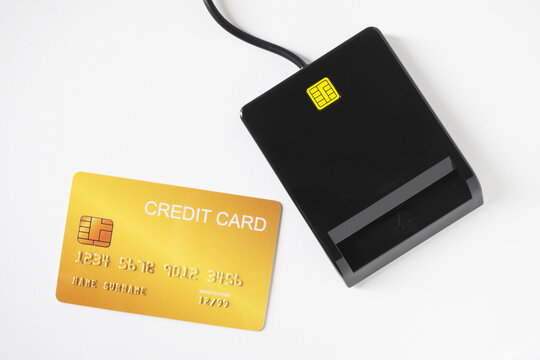 Credit card and credit card reader machine on white background.